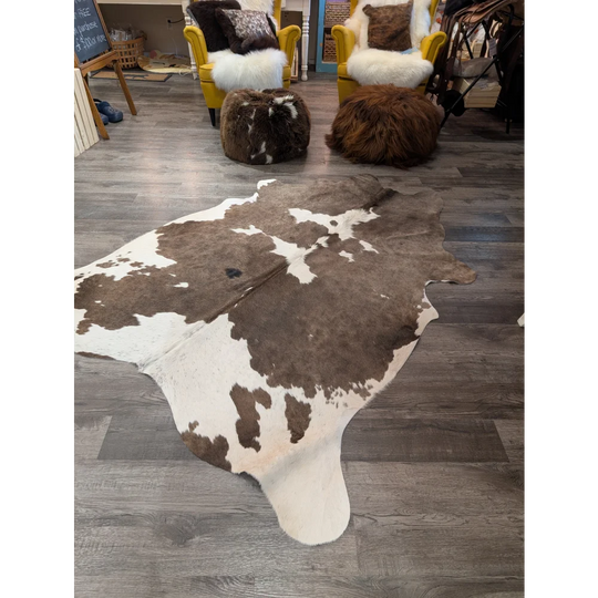 Large cowhide rug angus oliver with brown and white natural irregular patches measuring 79 by 67 inches