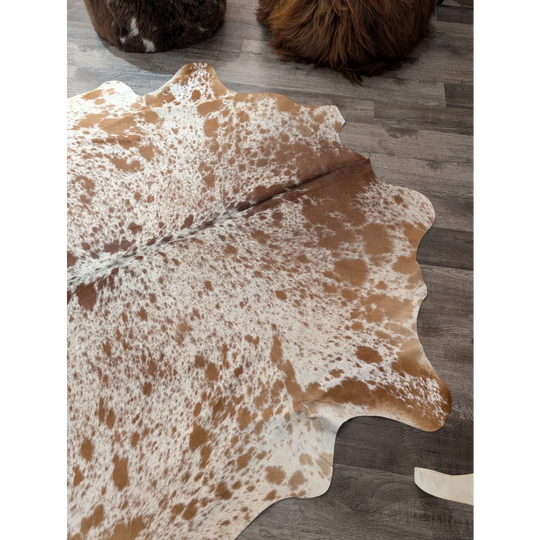 Large angus oliver cowhide rug in brown and white with natural irregular edges perfect for any room