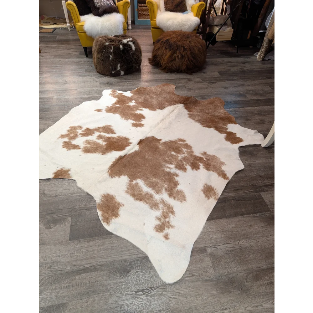 Large brown and white cowhide rug with natural fur texture perfect for stylish home decor by angus oliver