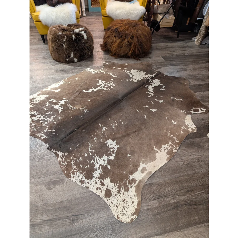 Large cowhide rug angus oliver with brown and white natural irregular patterns measuring 72 by 62 inches
