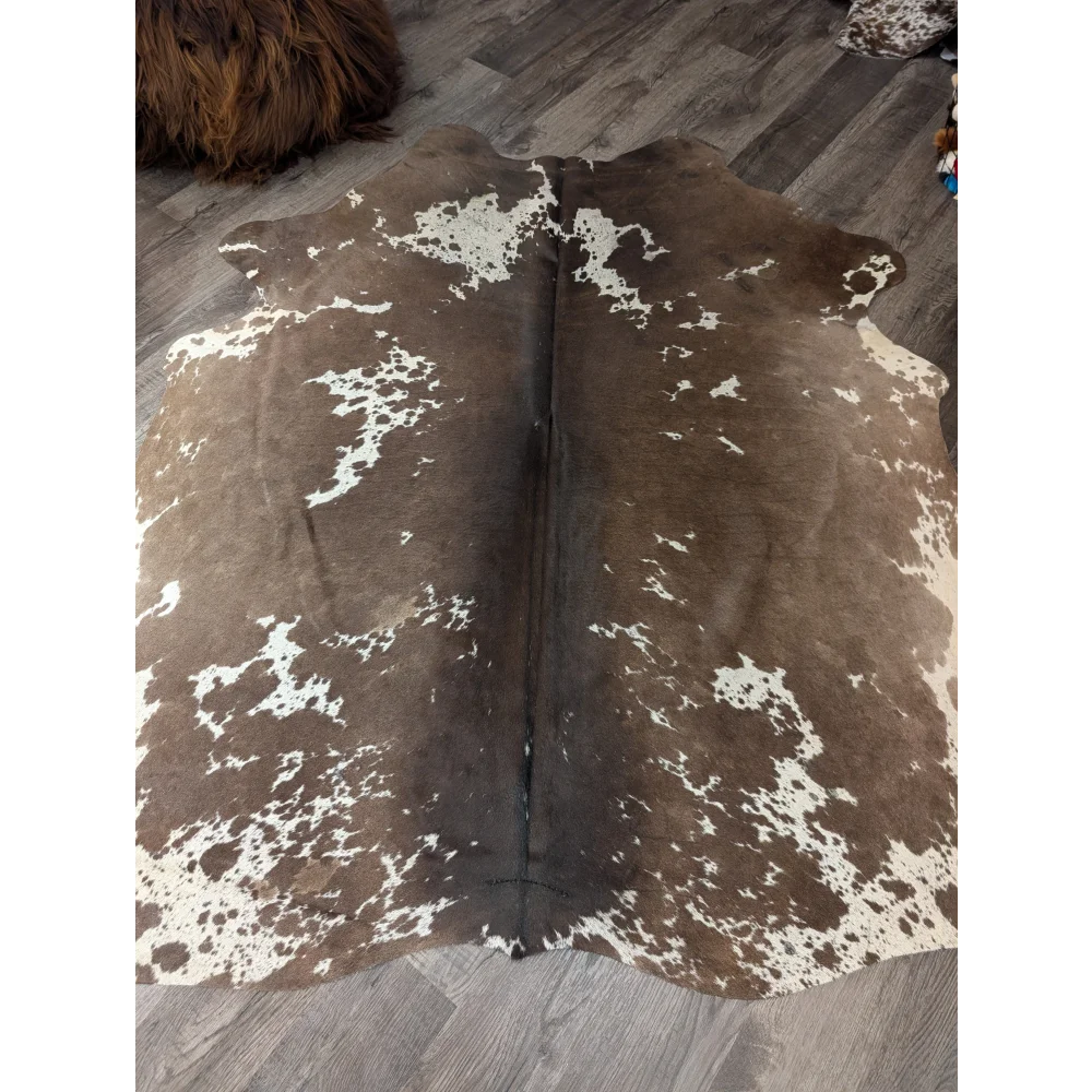 Large cowhide rug angus oliver with brown and white natural irregular patches measuring 72 by 62 inches