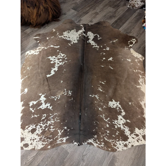 Large cowhide rug angus oliver with brown and white natural irregular patches measuring 72 by 62 inches