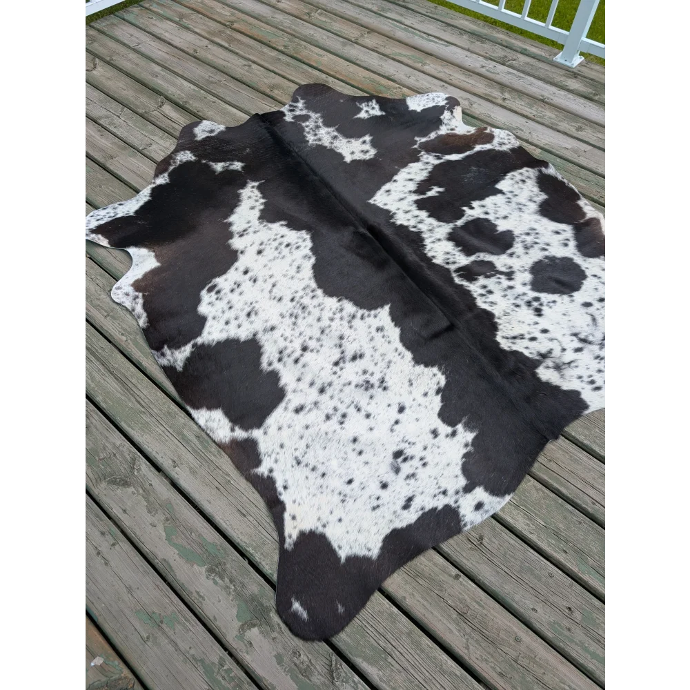 Large black and white cowhide rug with unique natural spotted pattern perfect for a stylish large cowhide decor