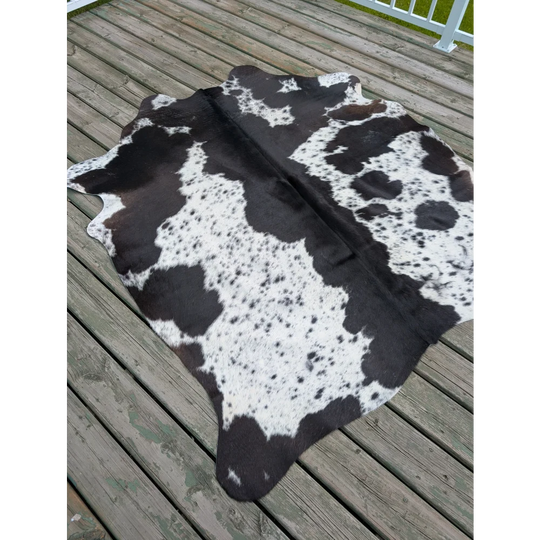 Large black and white cowhide rug with unique natural spotted pattern perfect for a stylish large cowhide decor