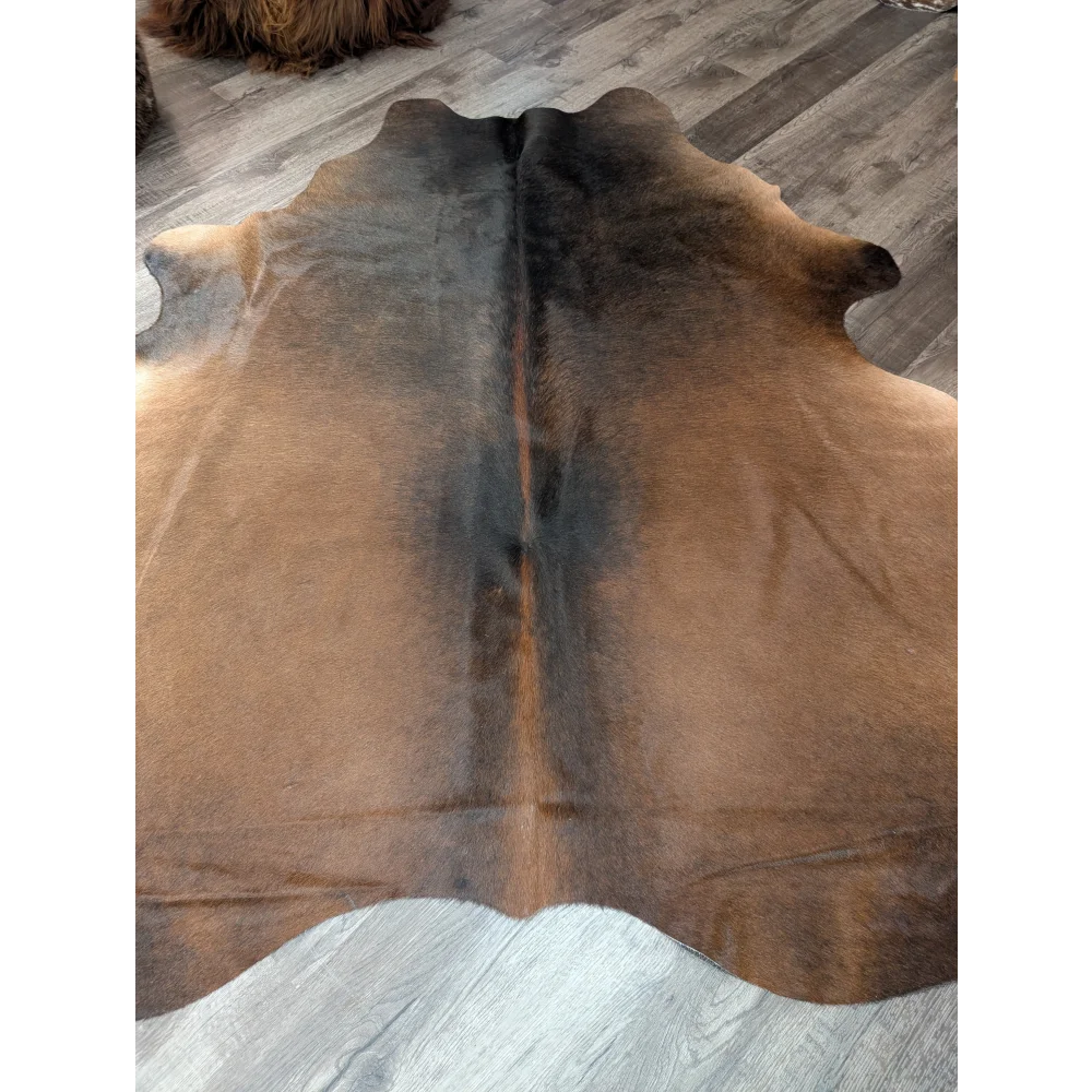 Large cowhide rug t40 77 x 66 featuring a natural brown and black angus oliver cowhide with a soft textured surface