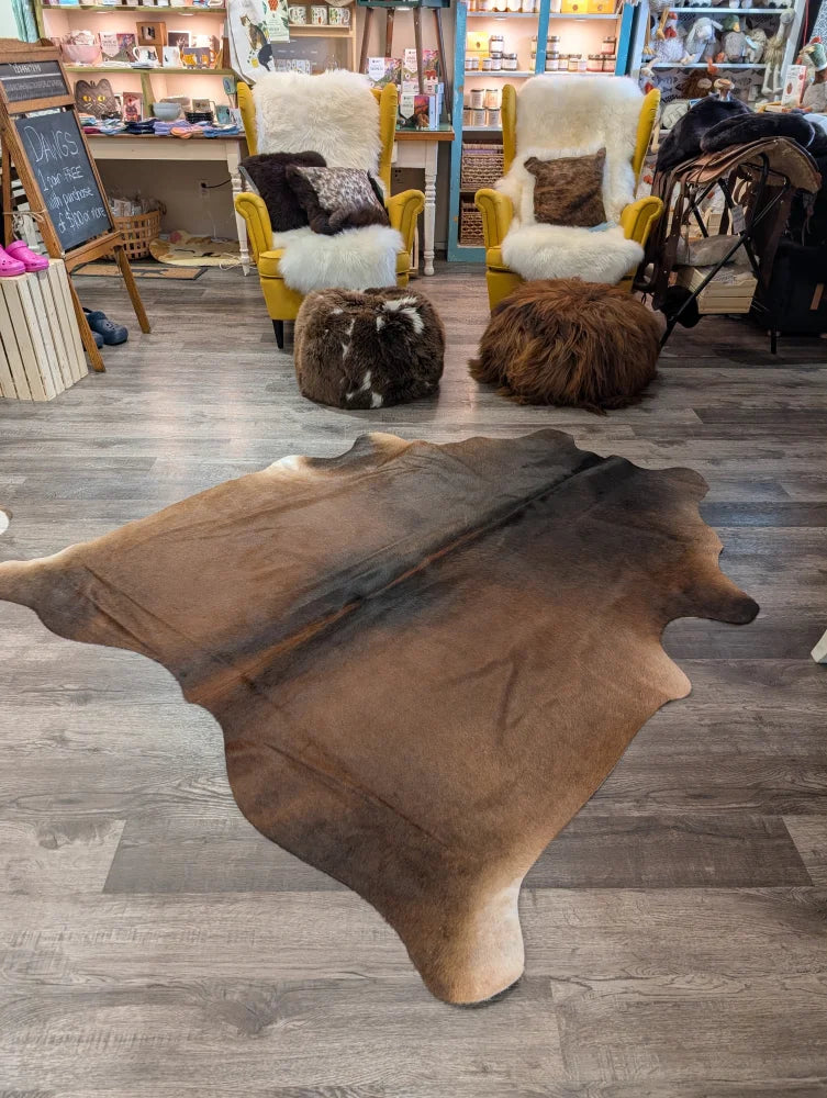 Brown large cowhide rug angus oliver with natural irregular edges and soft textured surface 77 x 66 inches