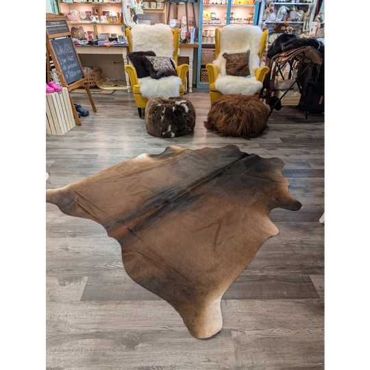 Brown large cowhide rug angus oliver with natural irregular edges and soft textured surface 77 x 66 inches