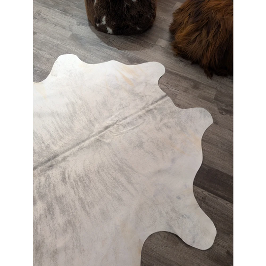 Large cowhide rug angus oliver with a white natural textured surface and subtle grayish markings 76 x 70 inches