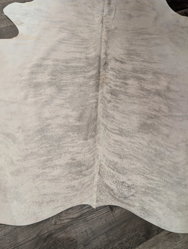 Large cowhide angus oliver rug in natural white with soft texture and subtle grayish markings perfect for home use