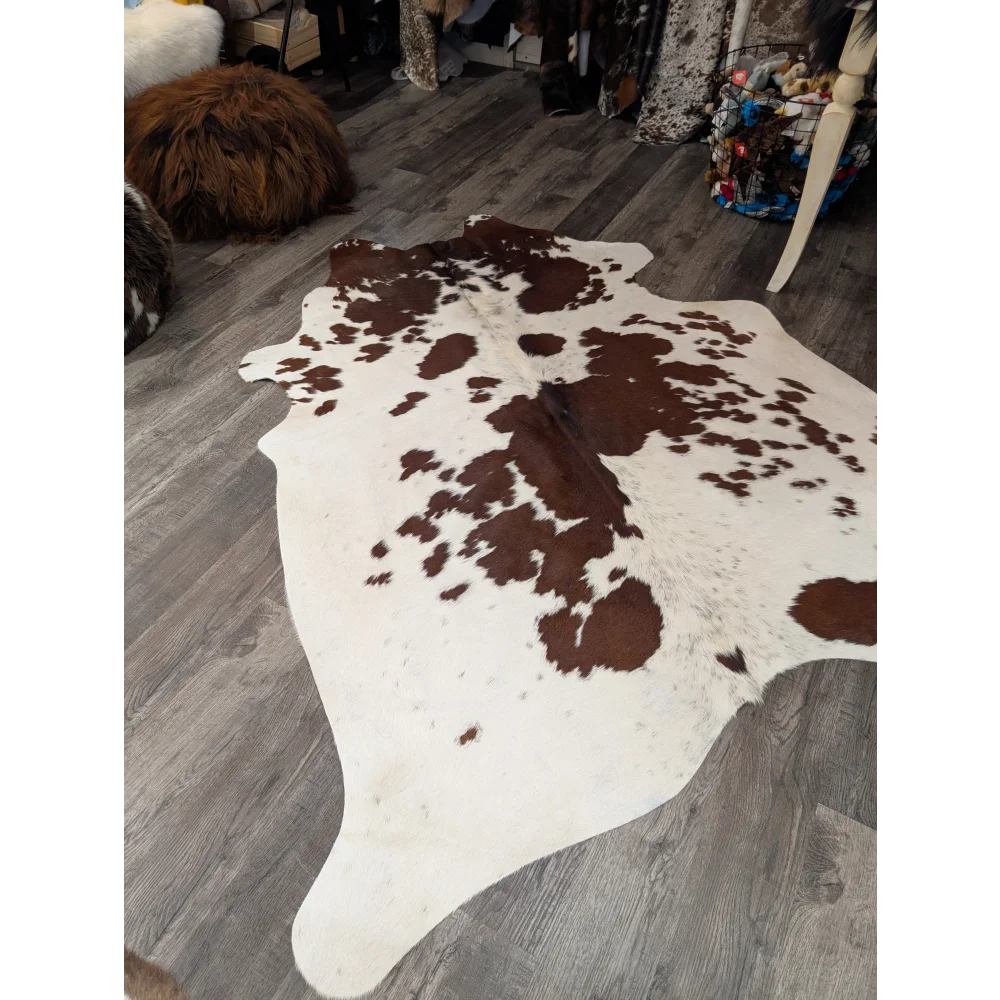 Large cowhide rug angus oliver with brown and white natural patches on creamy base perfect for stylish decor