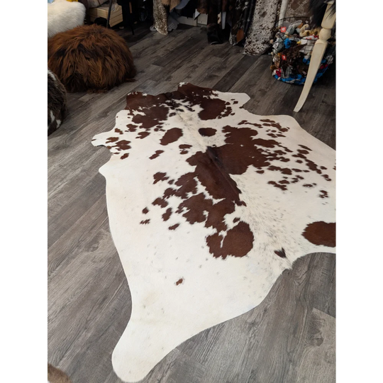 Large cowhide rug angus oliver with brown and white natural patches on creamy base perfect for stylish decor