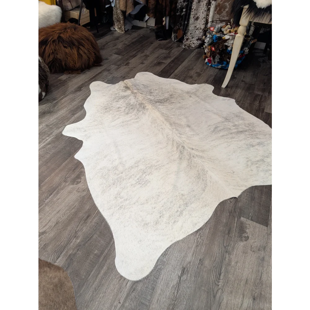 Large cowhide rug t44 74 x 65 white with natural edges and subtle gray speckled pattern by angus oliver