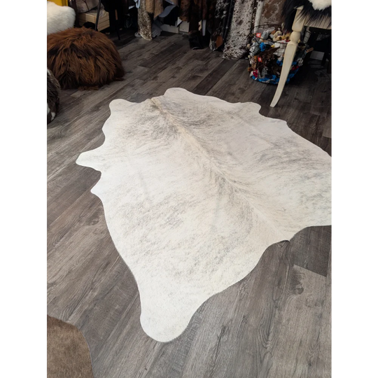 Large cowhide rug t44 74 x 65 white with natural edges and subtle gray speckled pattern by angus oliver