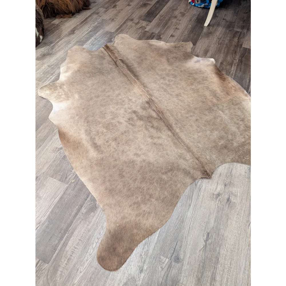 Natural tan large cowhide rug with soft textured surface and irregular edges from angus oliver t45 77 x 64