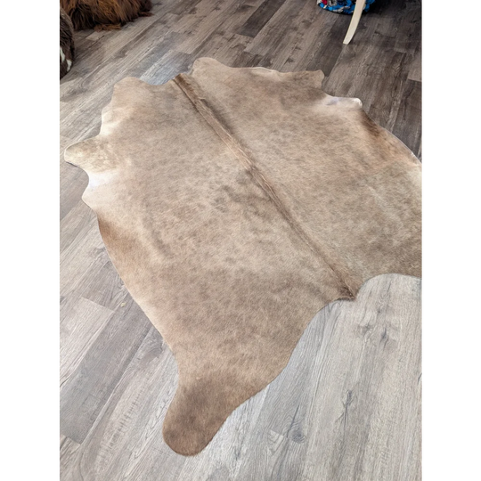 Natural tan large cowhide rug with soft textured surface and irregular edges from angus oliver t45 77 x 64