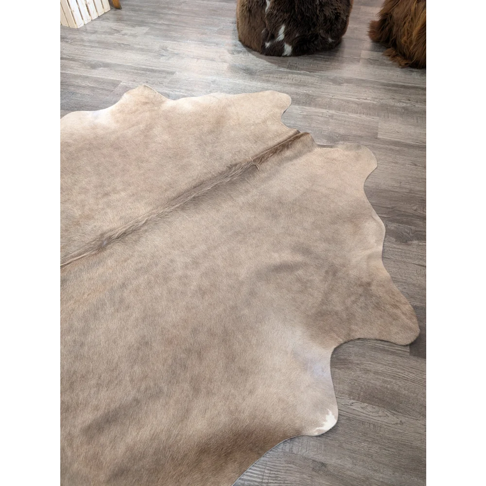 Natural tan angus oliver large cowhide rug with soft textured surface and irregular edges t45 77 x 64