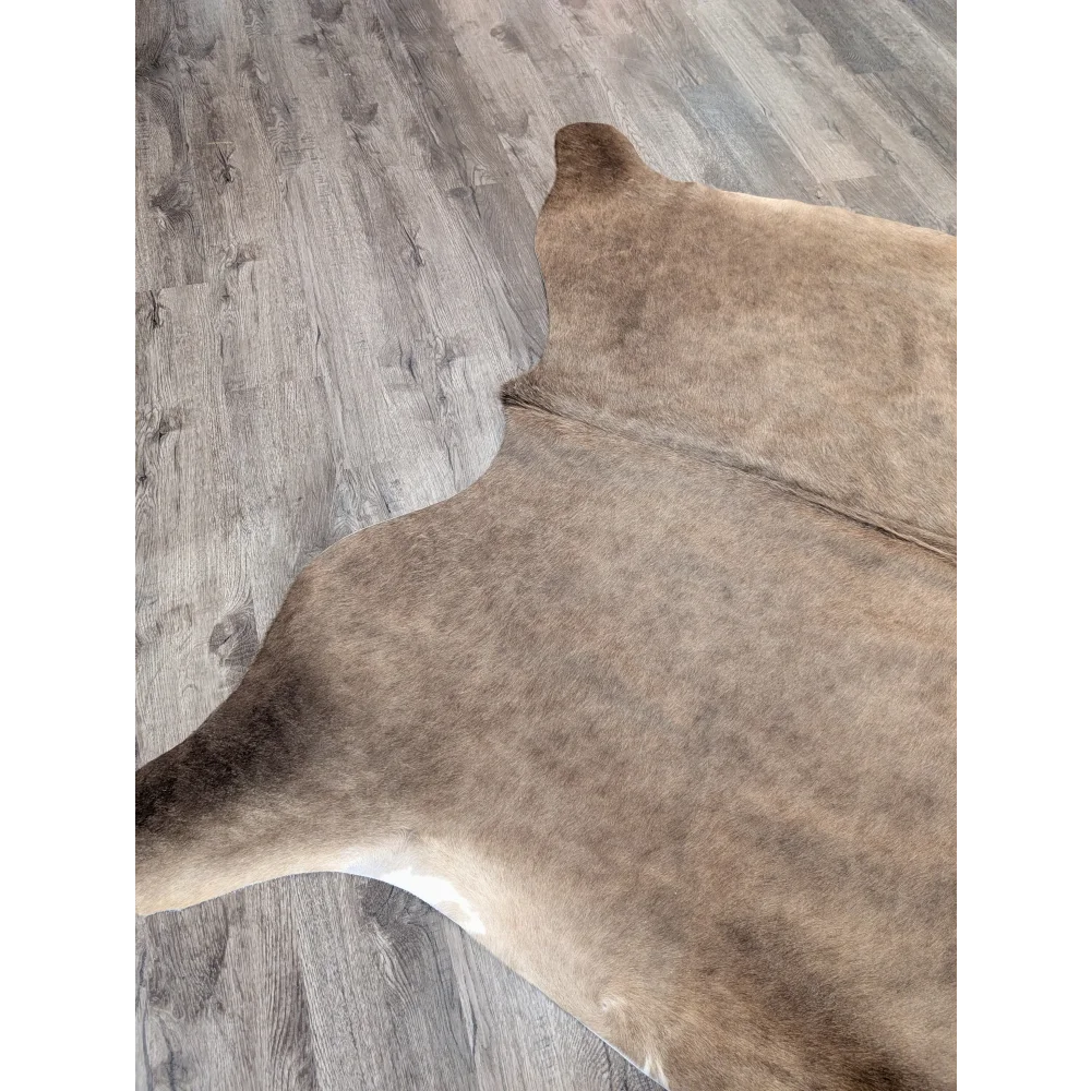 Brown angus oliver large cowhide rug with natural fur texture and subtle tone variations 77 by 64 inches