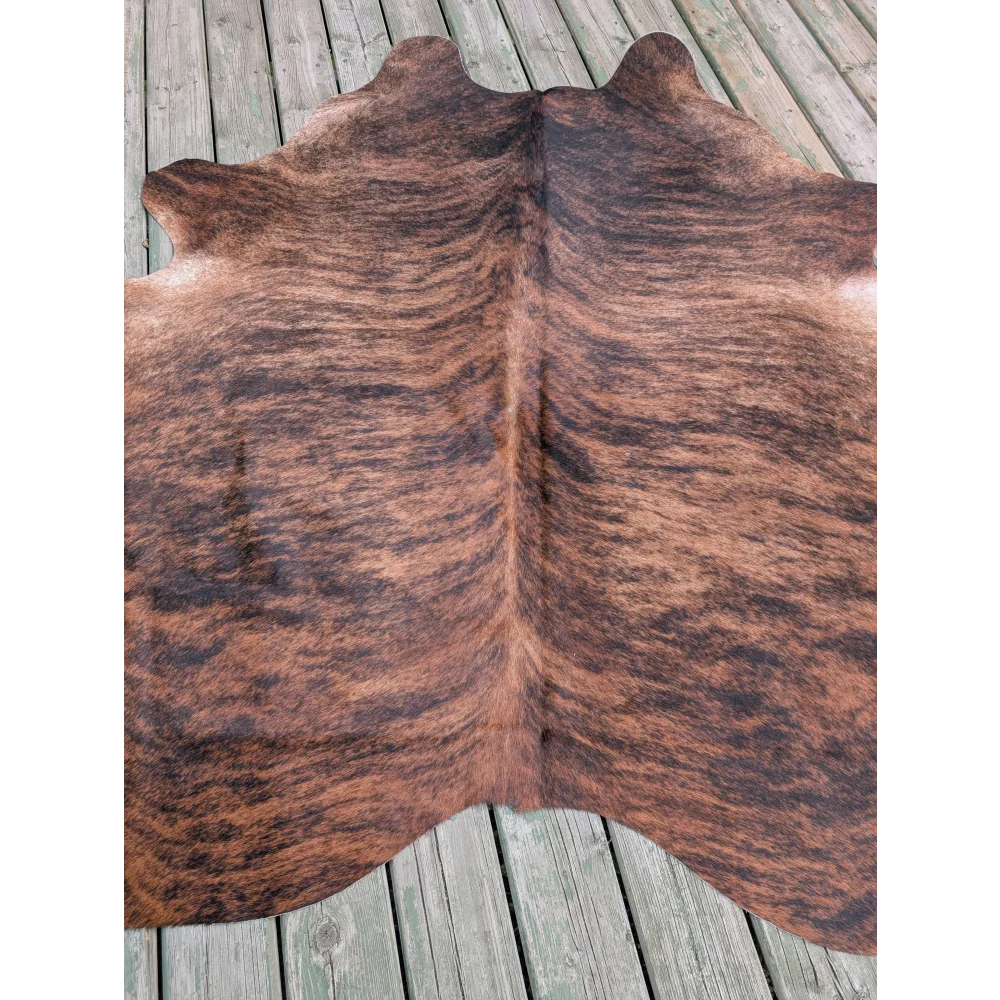Large cowhide rug with natural brown and black fur texture showcasing unique characteristics and large cowhide appeal