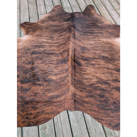 Large cowhide rug with natural brown and black fur texture showcasing unique characteristics and large cowhide appeal