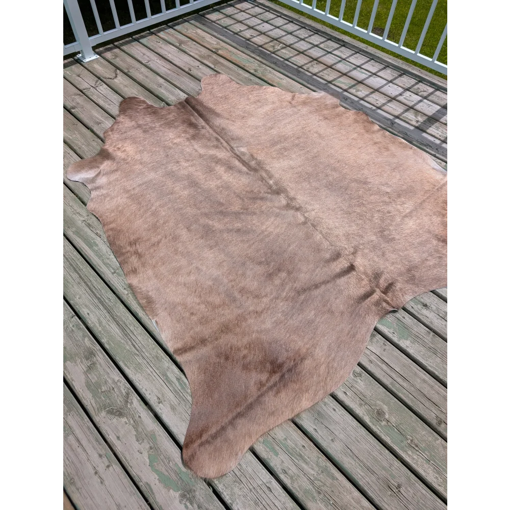 Large cowhide rug t9 with natural brown color soft textured surface and unique characteristics with irregular edges