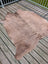 Large cowhide rug t9 with natural brown color soft textured surface and unique characteristics with irregular edges