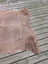 Large cowhide rug in light brown with unique characteristics and a soft, slightly textured surface measuring 73.5 x 68 inches