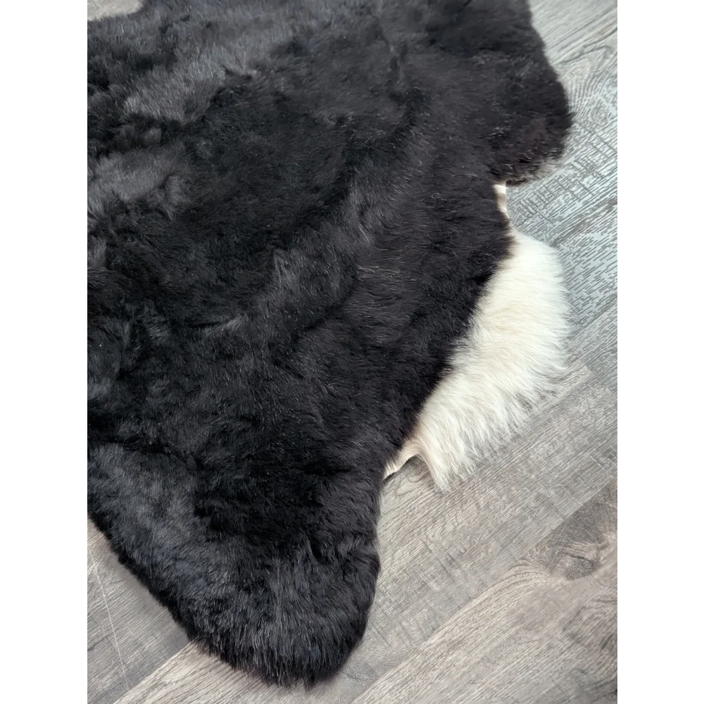 Large 43 x 33 black and white icelandic sheepskin rug with plush natural short wool texture perfect for cozy spaces
