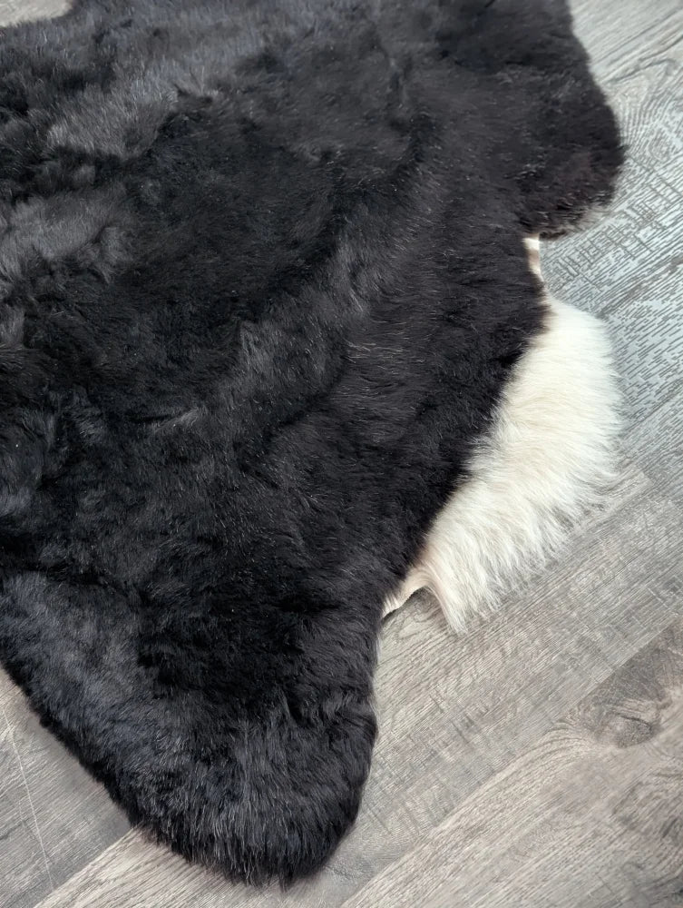 Large 43 x 33 black and white icelandic sheepskin rug with plush natural short wool texture perfect for cozy spaces