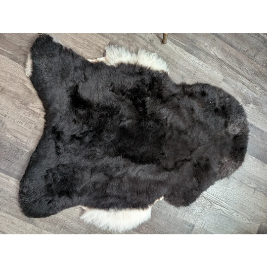 Large black and white fluffy icelandic sheepskin rug with short wool texture perfect for cozy decor