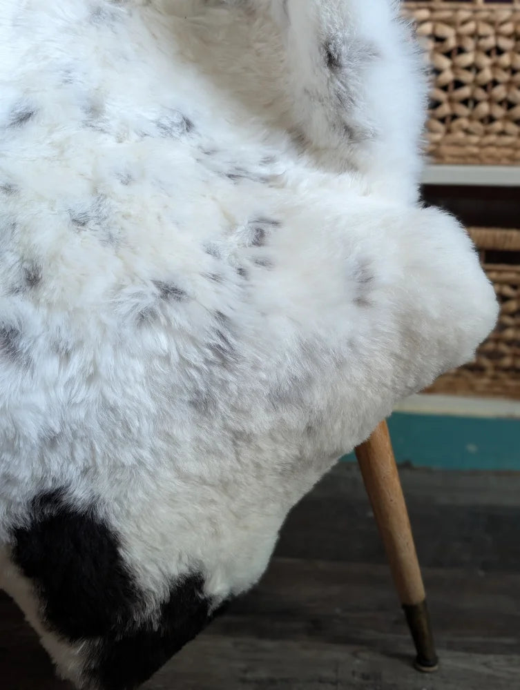 White and black spotted icelandic sheepskin rug with soft fluffy faux fur perfect as a spotted icelandic sheepskin throw