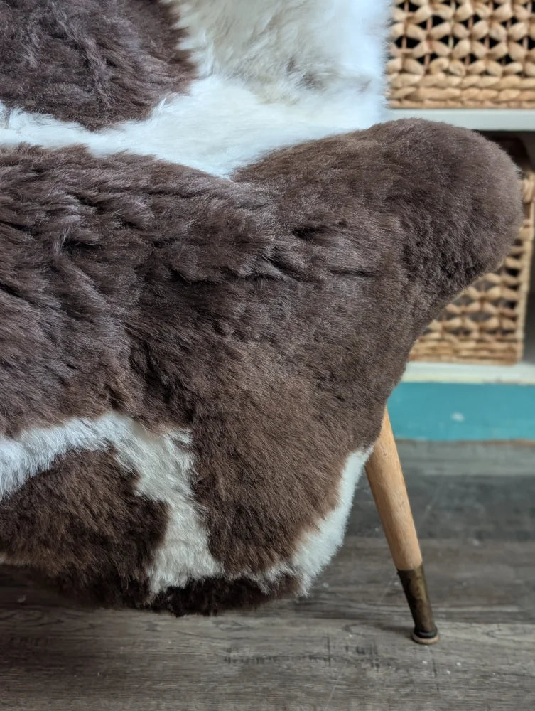 Brown and white spotted icelandic sheepskin chair cover with plush natural fur texture 45 by 31 inches large