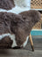 Brown and white spotted icelandic sheepskin chair cover with plush natural fur texture 45 by 31 inches large