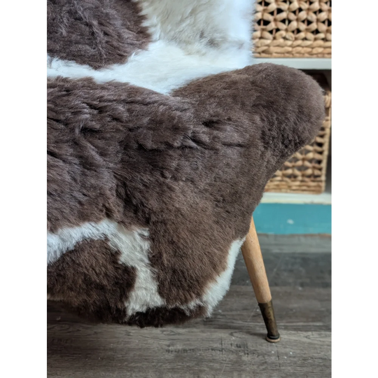 Brown and white spotted icelandic sheepskin chair cover with plush natural fur texture 45 by 31 inches large