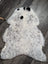 A plush large icelandic sheepskin rug in white and gray with three black spots perfect as a medium spotted icelandic decor