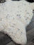 White spotted icelandic sheepskin rug with soft curly fur and dark gray speckles medium spotted icelandic style