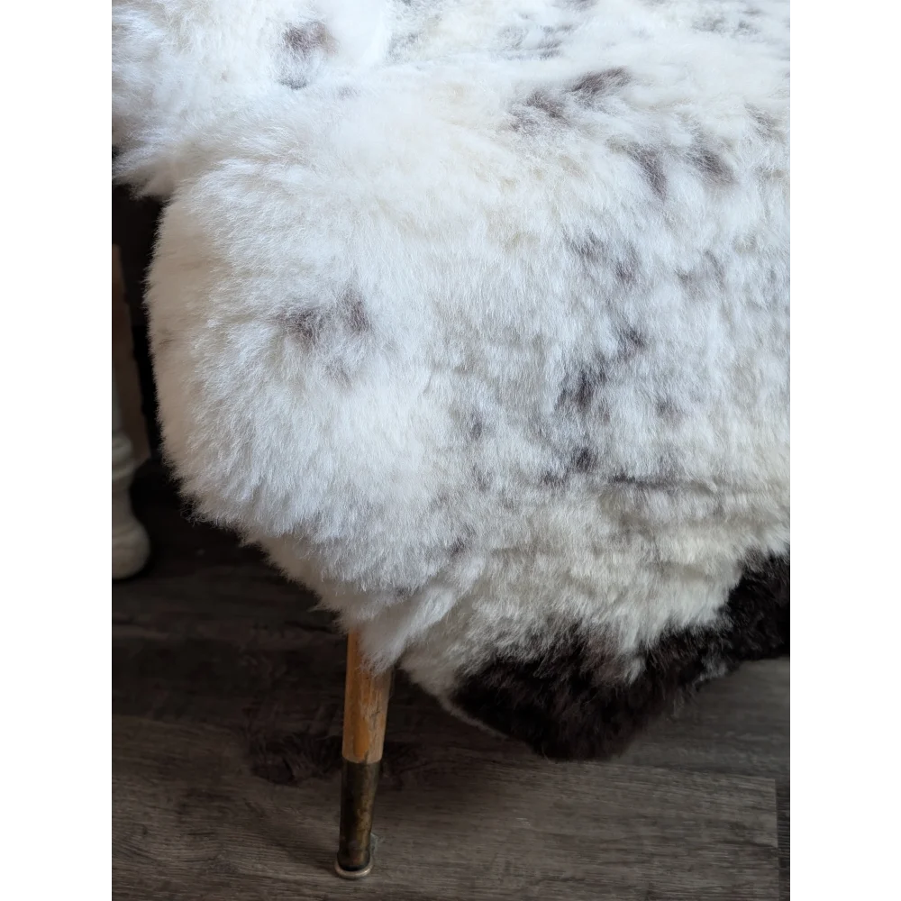 Large spotted icelandic sheepskin rug in white and gray speckled short wool with a soft fluffy texture