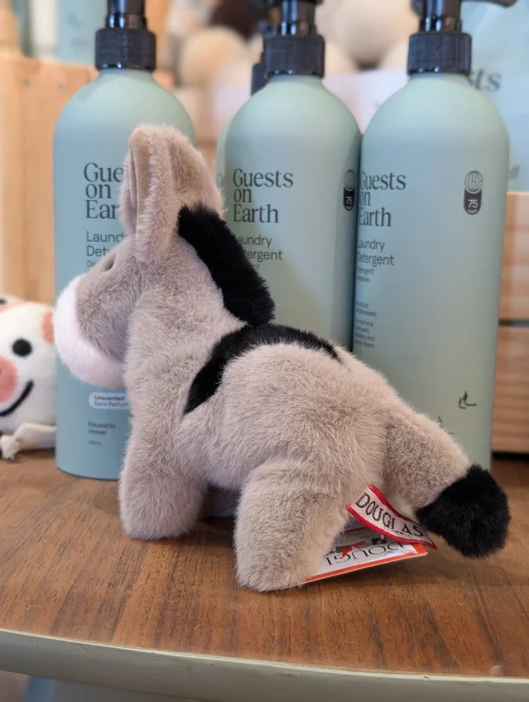 A plush donkey toy called The Donkey with soft beige fur and black accents on ears back and tail