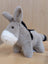 The donkey plush toy is gray with black accents, a white muzzle, and soft textured fur for cuddling