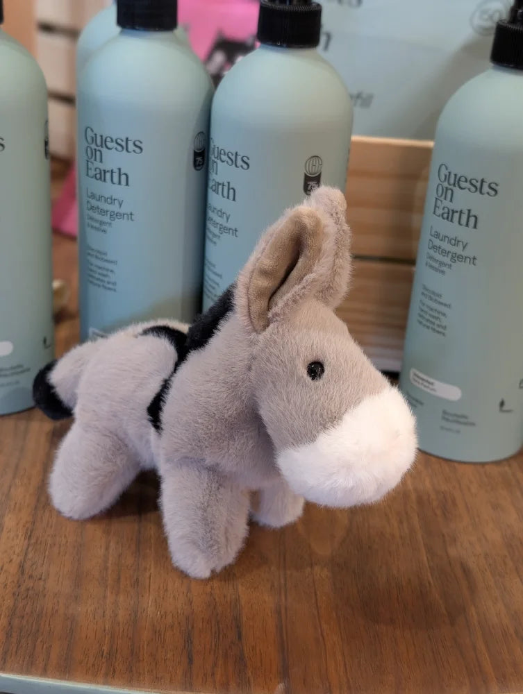 The donkey is a soft plush gray donkey toy with black markings white muzzle and tan ears perfect for cuddling