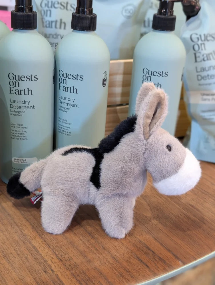 A soft gray and black plush donkey toy with a white muzzle called the donkey perfect for cuddling and play