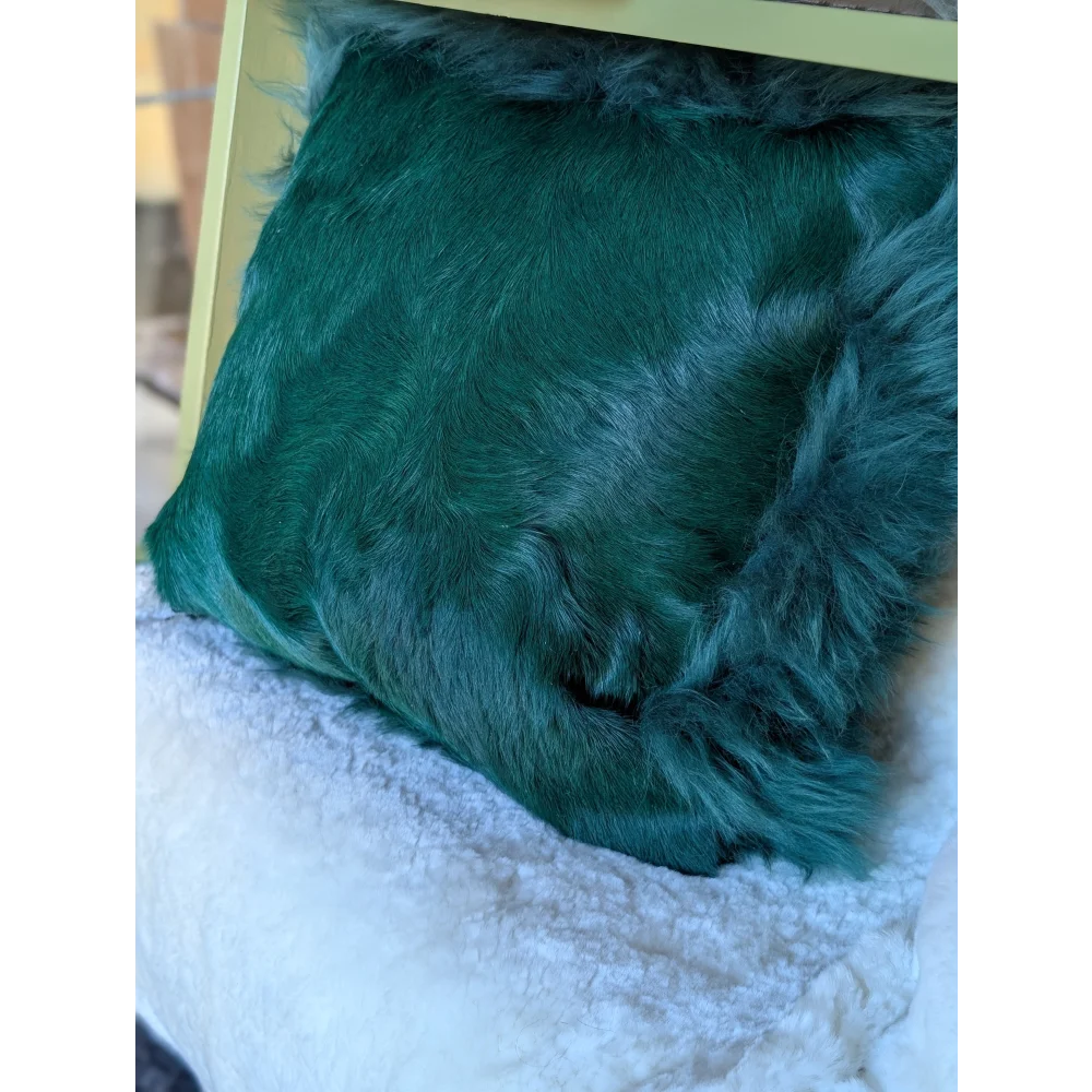 The green cushion emerald green faux fur throw pillow with plush texture and slightly frayed edges dyed green style