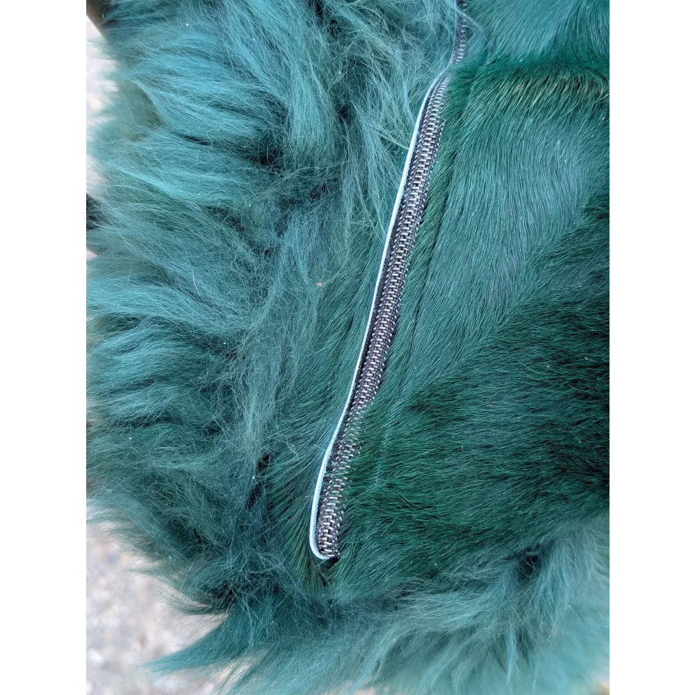 The green cushion features a dyed green plush faux fur with a sleek metallic zipper for angus oliver style