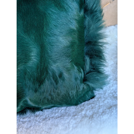The green cushion emerald green faux fur throw blanket with plush dyed green texture by angus oliver