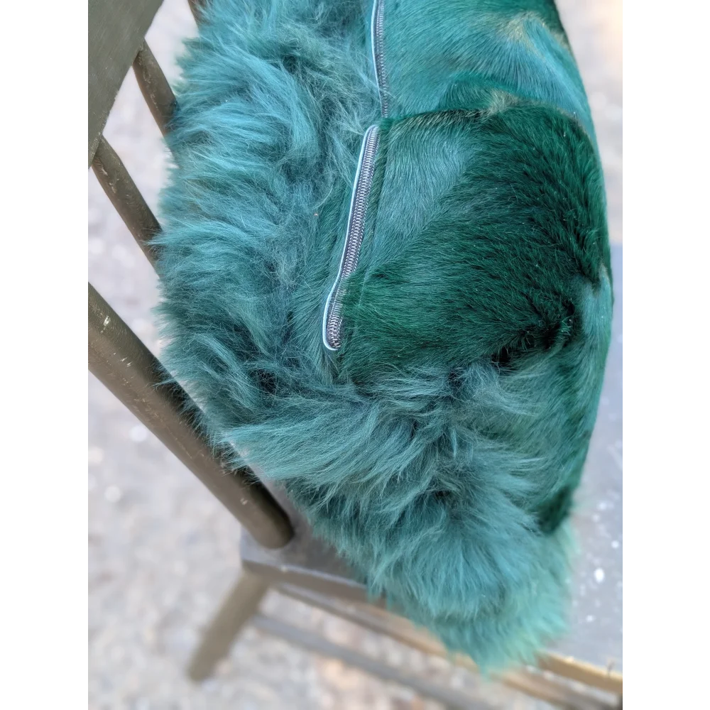 The green cushion plush teal-green faux fur handbag with silver zipper featuring dyed green angus oliver style