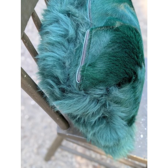 The green cushion plush teal-green faux fur handbag with silver zipper featuring dyed green angus oliver style