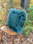 Teal faux fur backpack with plush fluffy texture and soft dense fibers inspired by green sheepskin from sewing studio