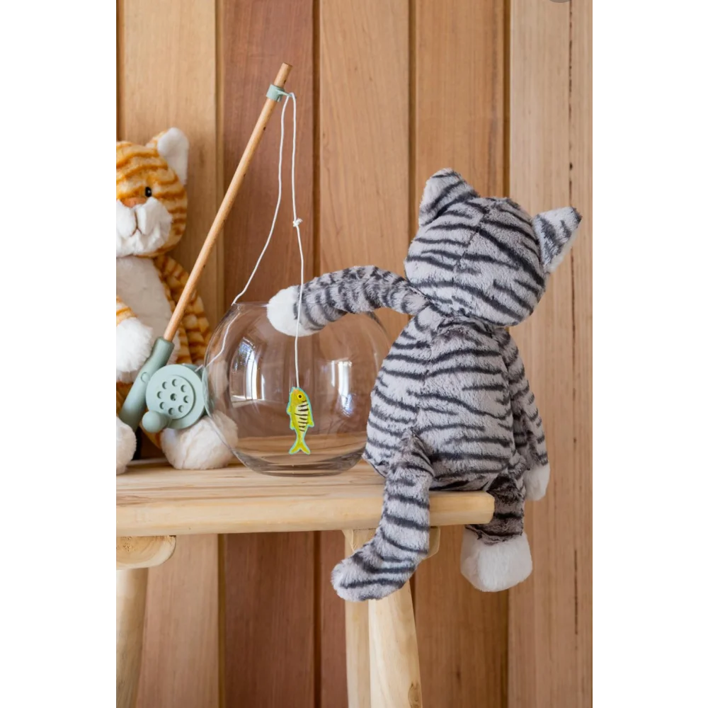 Cute gray tabby cat plush toy with sheepskin fishing rod, hanging on chair