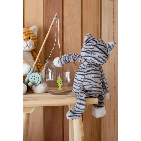 Cute gray tabby cat plush toy with sheepskin fishing rod, hanging on chair