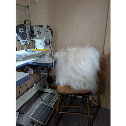 The moo cushion is a plush black and white speckled cowhide pillow with soft long wool white faux fur trim perfect for angus oliver fans