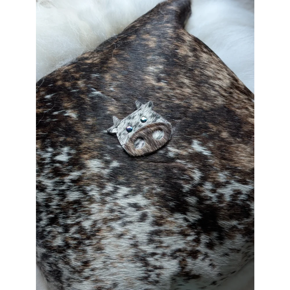 A small silver cow brooch with black bead eyes and textured snout perfect for sewing machines and angus oliver fans